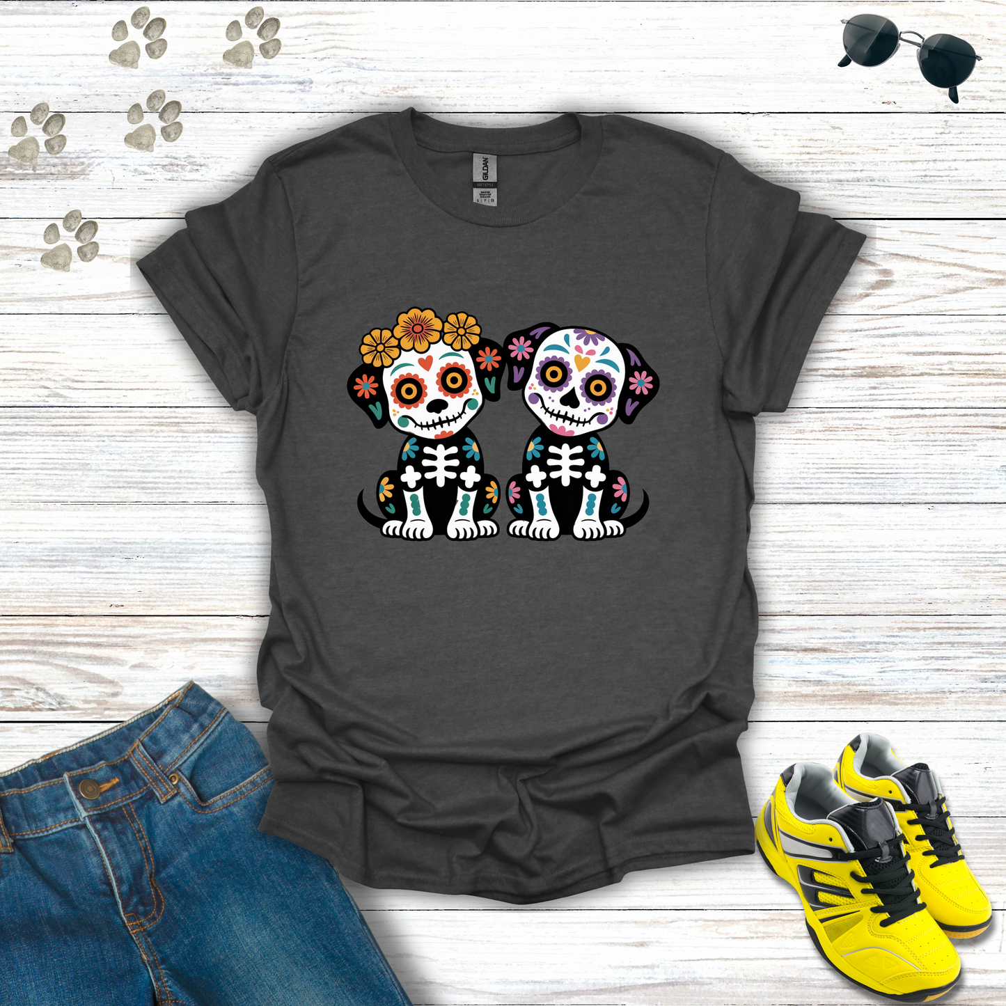 Dark Heather t-shirt with skull dog design on a wooden surface with jeans and sneakers.