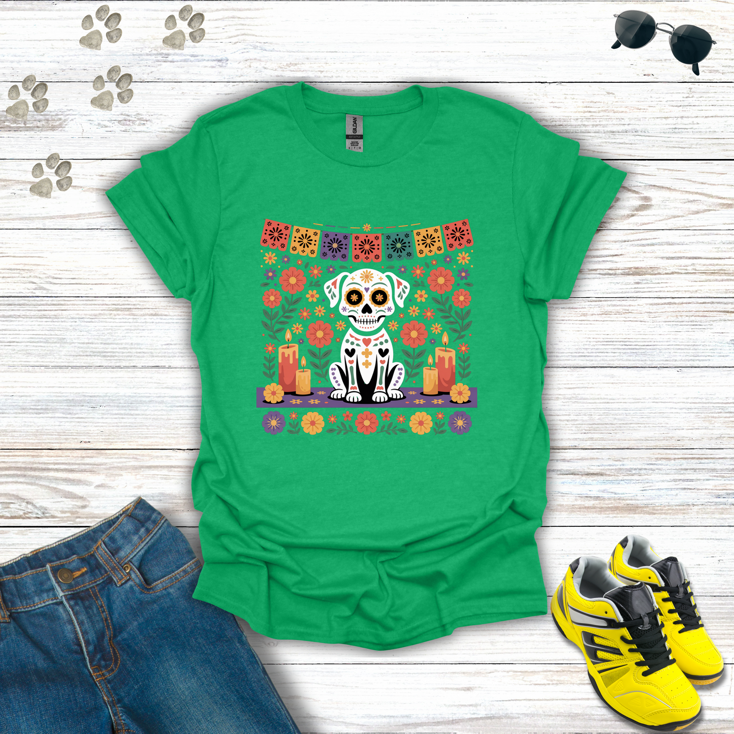 Heather Irish Green t-shirt with a colorful dog skull design on a wooden surface with jeans and shoes.