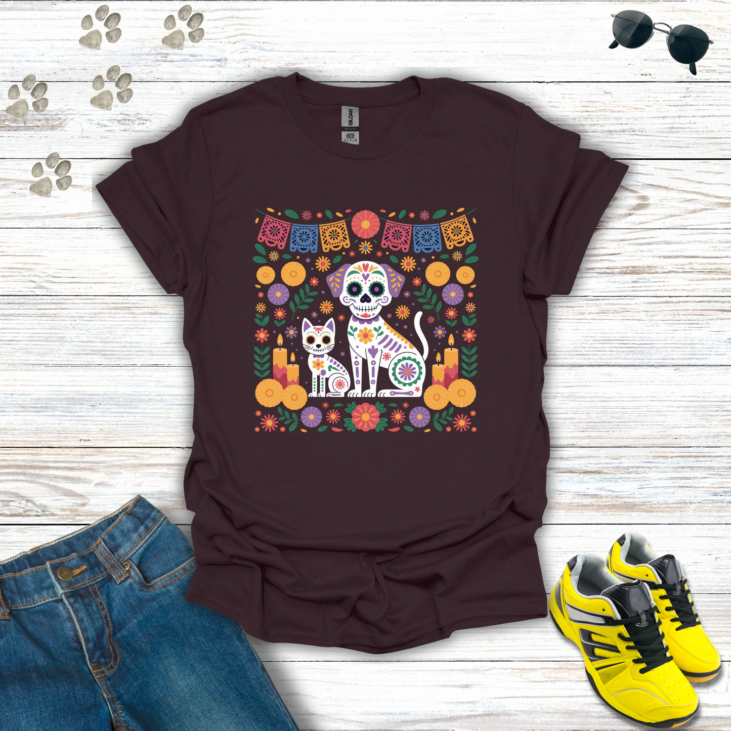 Dark Chocolate t-shirt with a colorful graphic of a cat and dog skeleton, jeans, and yellow sneakers on a wooden surface.