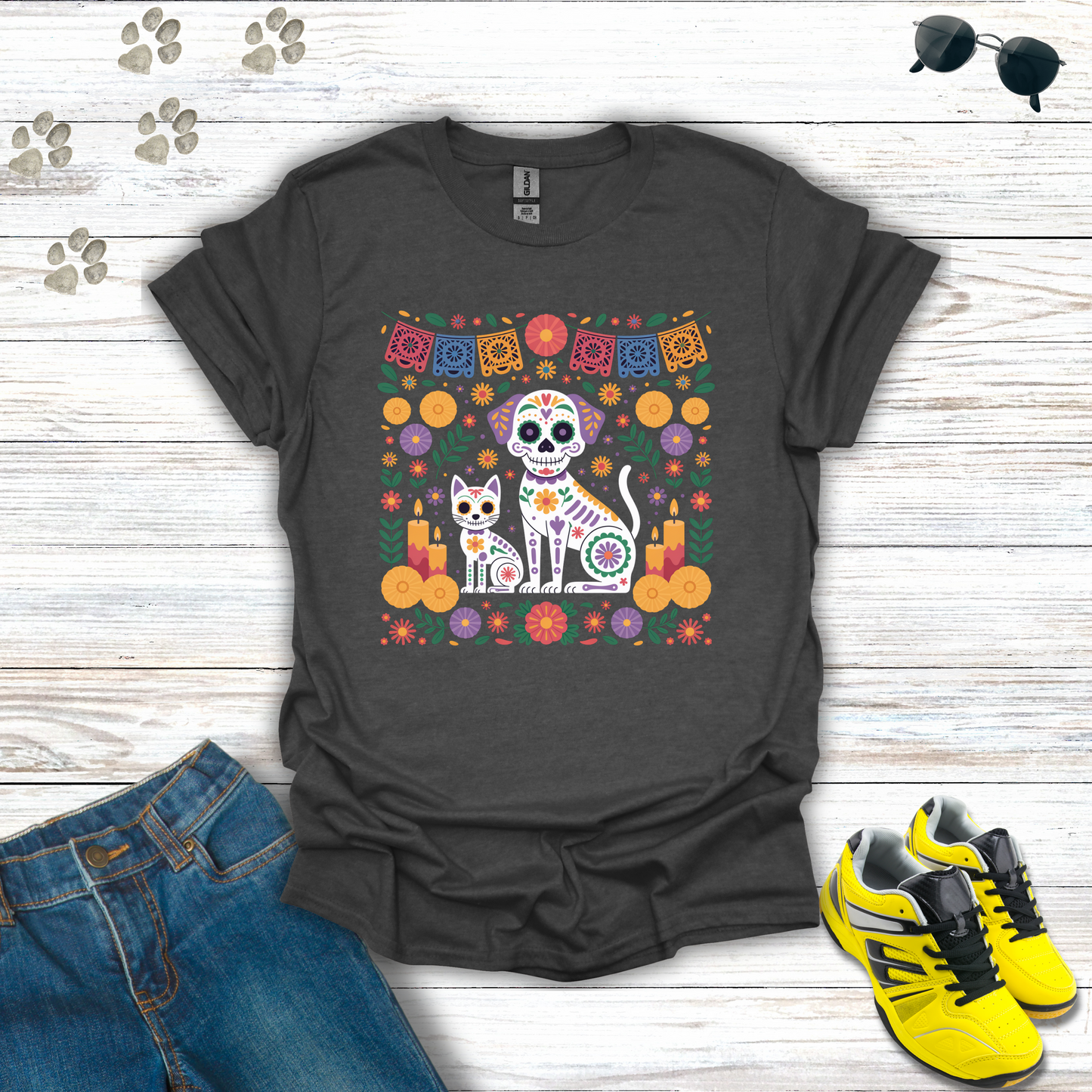 Dark Heather t-shirt with a colorful graphic of a cat and dog skeleton, jeans, and yellow sneakers on a wooden surface.