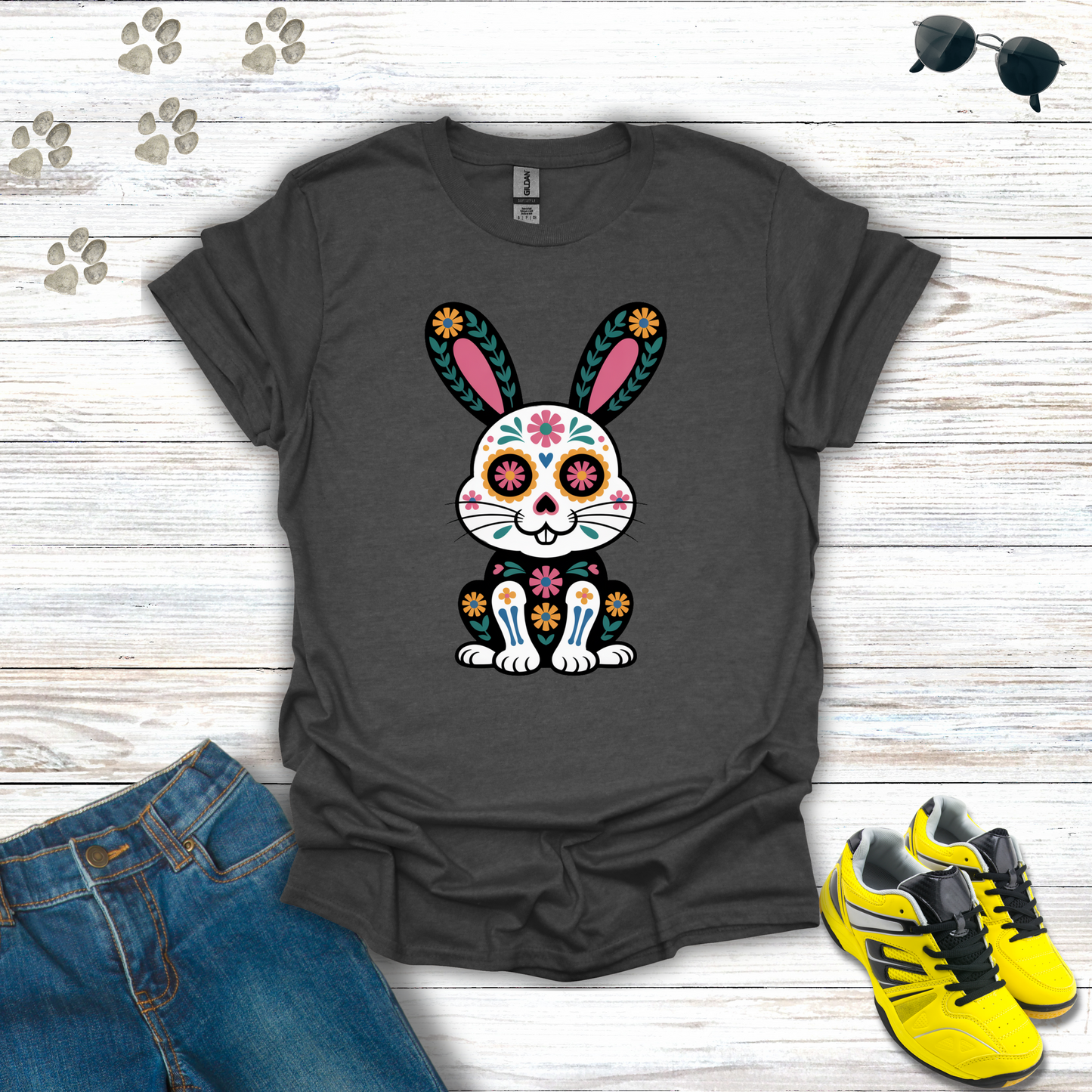 Dark Heather t-shirt with a colorful bunny design on a wooden surface with jeans and sneakers.