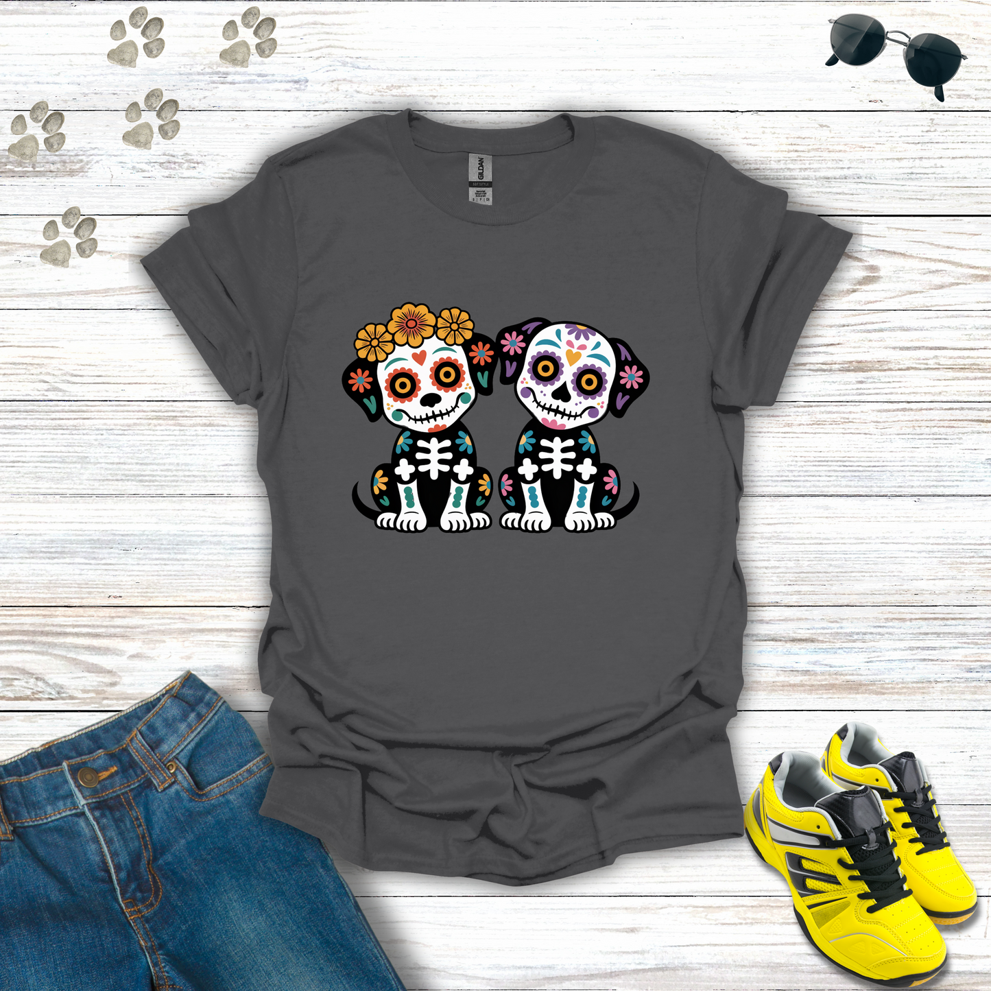 Charcoal t-shirt with skull dog design on a wooden surface with jeans and sneakers.
