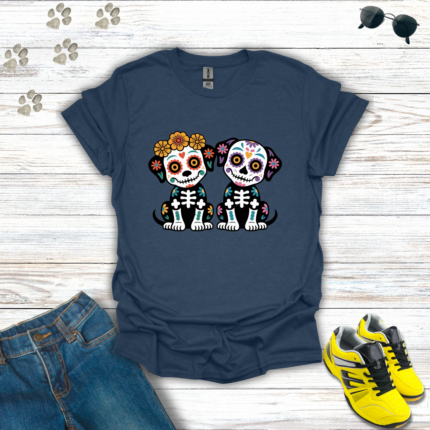Heather Navy blue t-shirt with skull dog design on a wooden surface with jeans and sneakers.