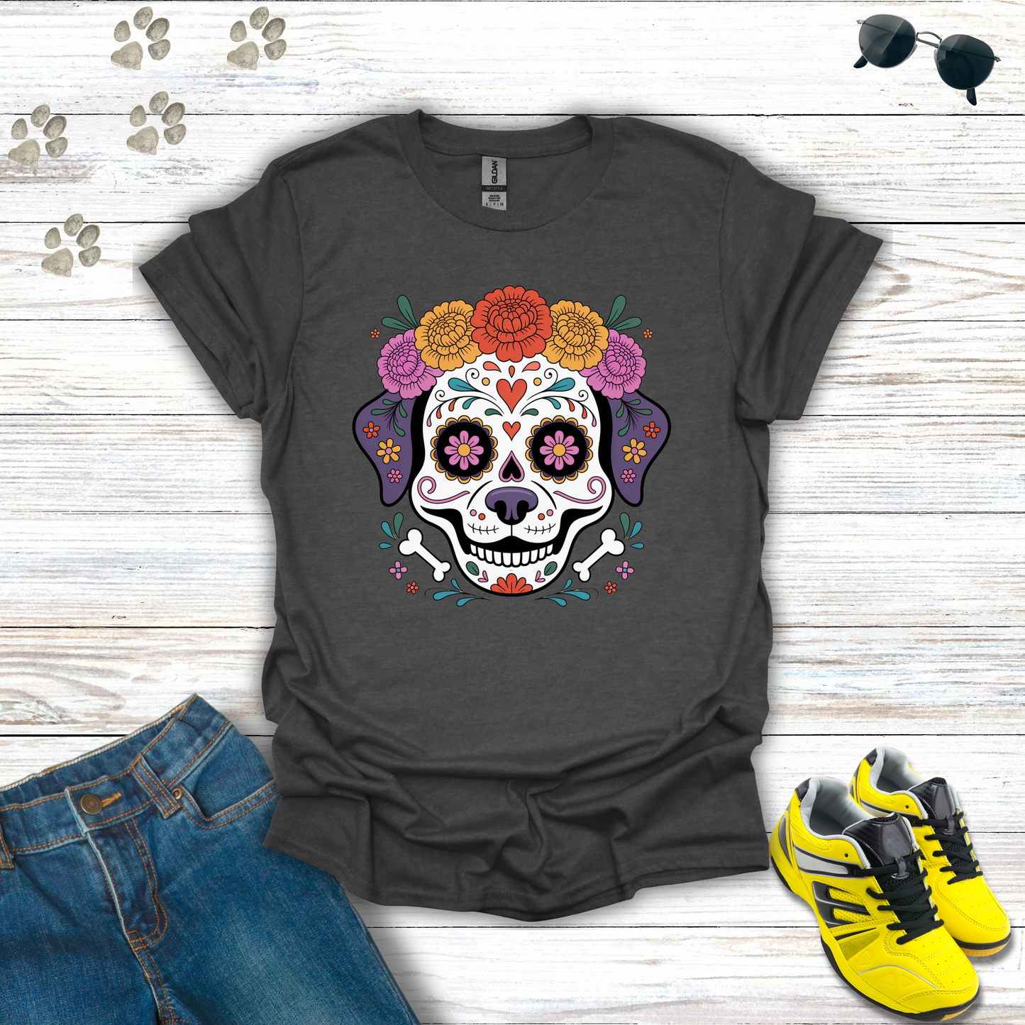 Dark Heather t-shirt with colorful skull design on a wooden surface with jeans and sneakers.