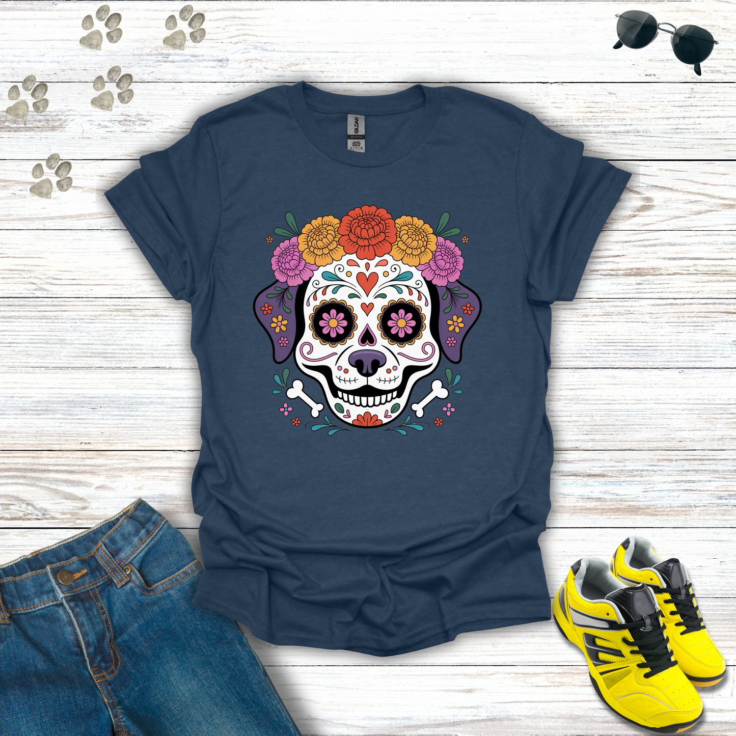 Heather Navy blue t-shirt with colorful skull design on a wooden surface with jeans and sneakers.
