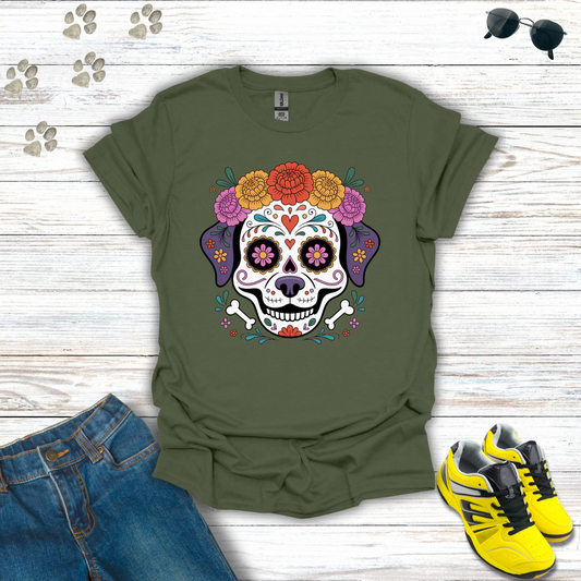 Military Green t-shirt with a colorful skull design on a wooden surface with jeans and sneakers.