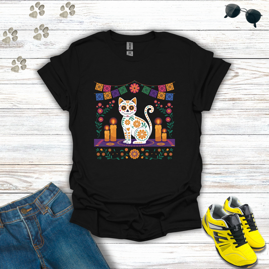 Black t-shirt with a colorful cat design on a wooden surface with jeans and sneakers.