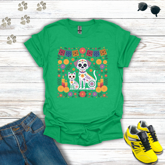 Heather Irish Green t-shirt with a colorful graphic of two dogs in skeleton costumes on a wooden surface with jeans and shoes.