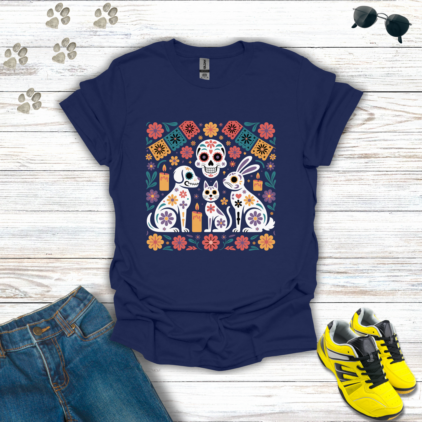 Navy blue t-shirt with colorful graphic design on a wooden surface with jeans and sneakers.