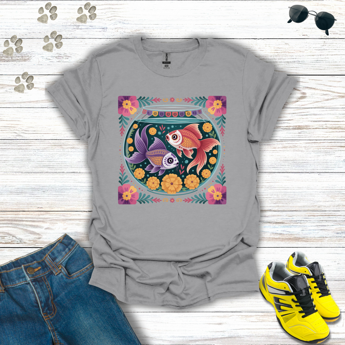 Sport Gray t-shirt with fish bowl design on a wooden surface with jeans and sneakers.