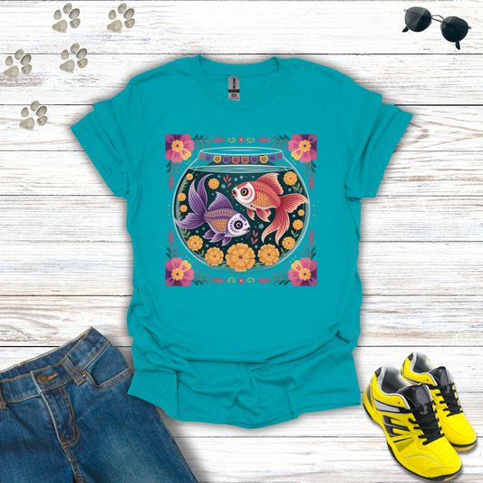Tropical Blue t-shirt with fish bowl design on a wooden surface with jeans and sneakers.