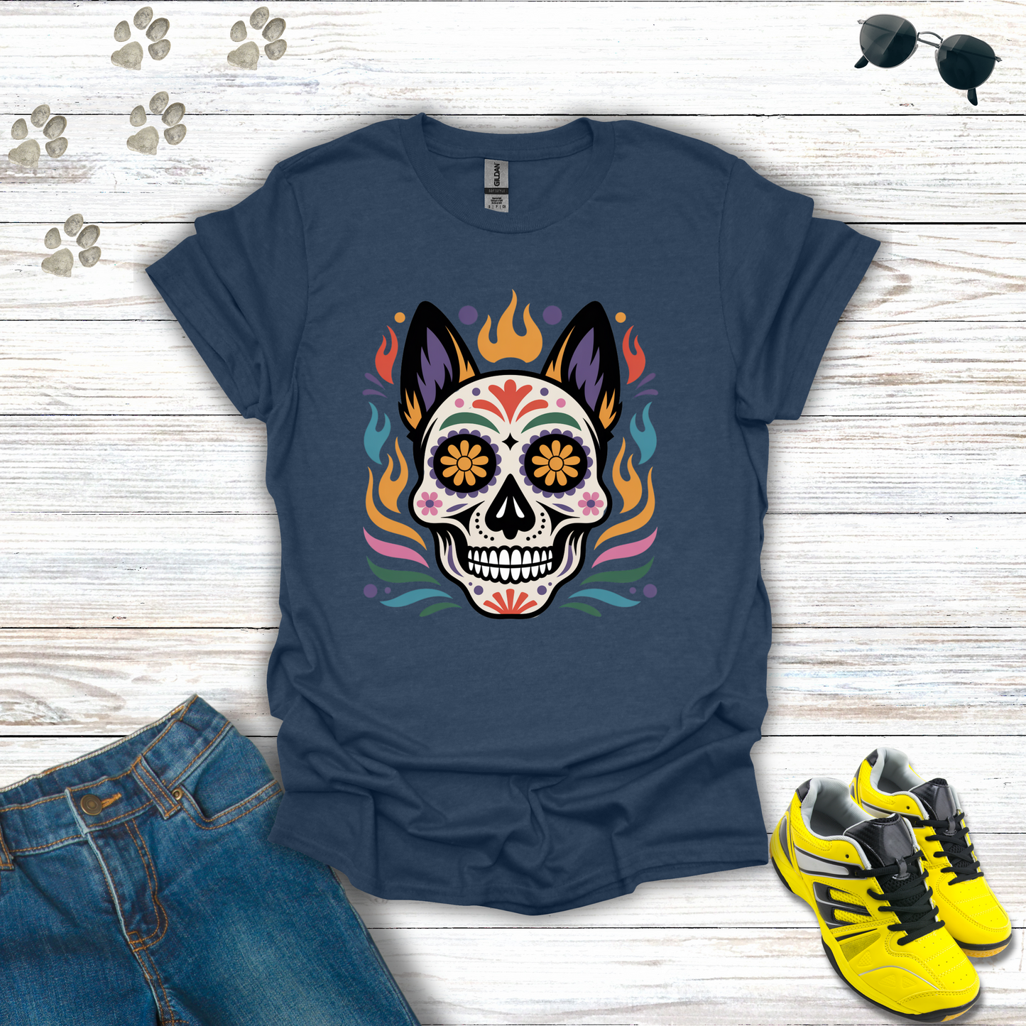 Heather Navy t-shirt with colorful skull design on a wooden surface with jeans and sneakers.