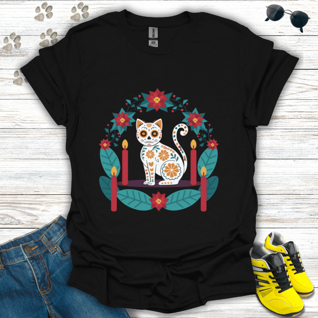 Christmas Sugar Skull Cat T-Shirt on black Gildan tee featuring a white sugar-skull cat surrounded by poinsettias, teal leaves, and candles — vibrant festive folk-art design.