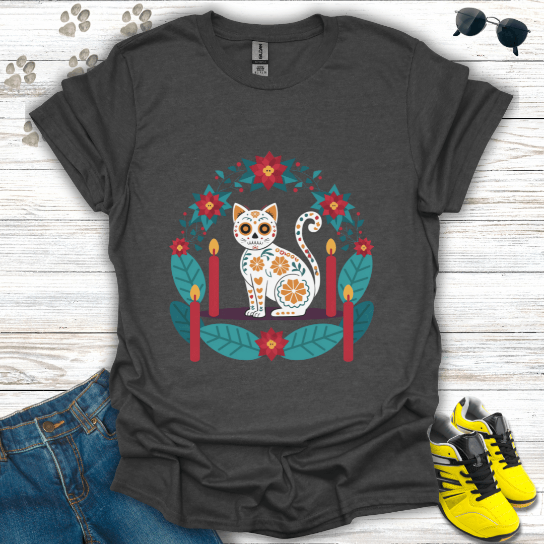Christmas Sugar Skull Cat T-Shirt on dark heather Gildan tee with sugar-skull cat art framed by poinsettias, holly leaves, and candles — modern festive pet design.
